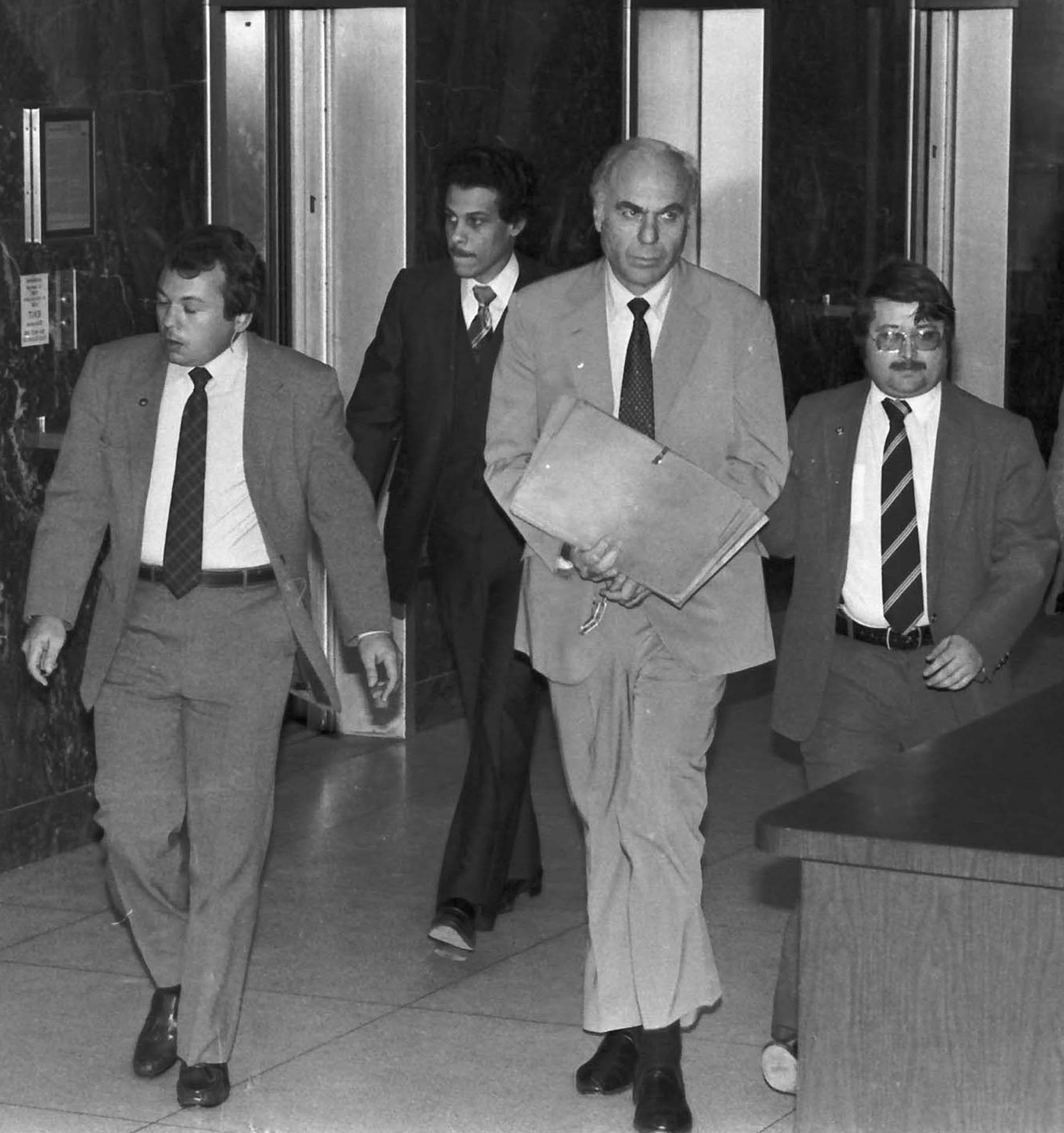 Edwin Wilson, center, leaves federal court after a day of jury selection accompanied by U.S. Marshals in Houston