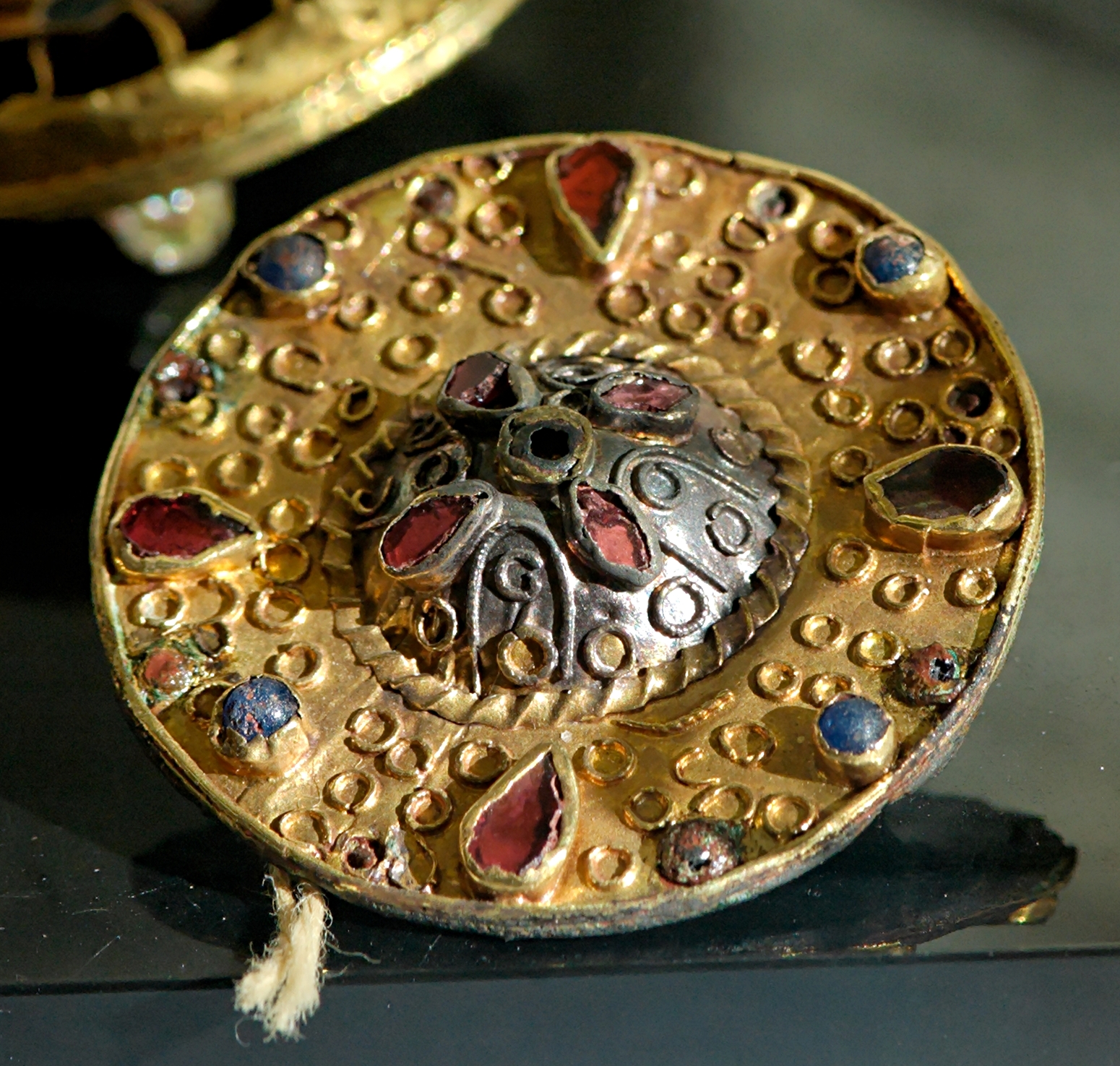 Merovingian fibula. Gold, garnets and glass paste and precious stones. Found in the Merovingian cemetary of Blondefontaine, France.