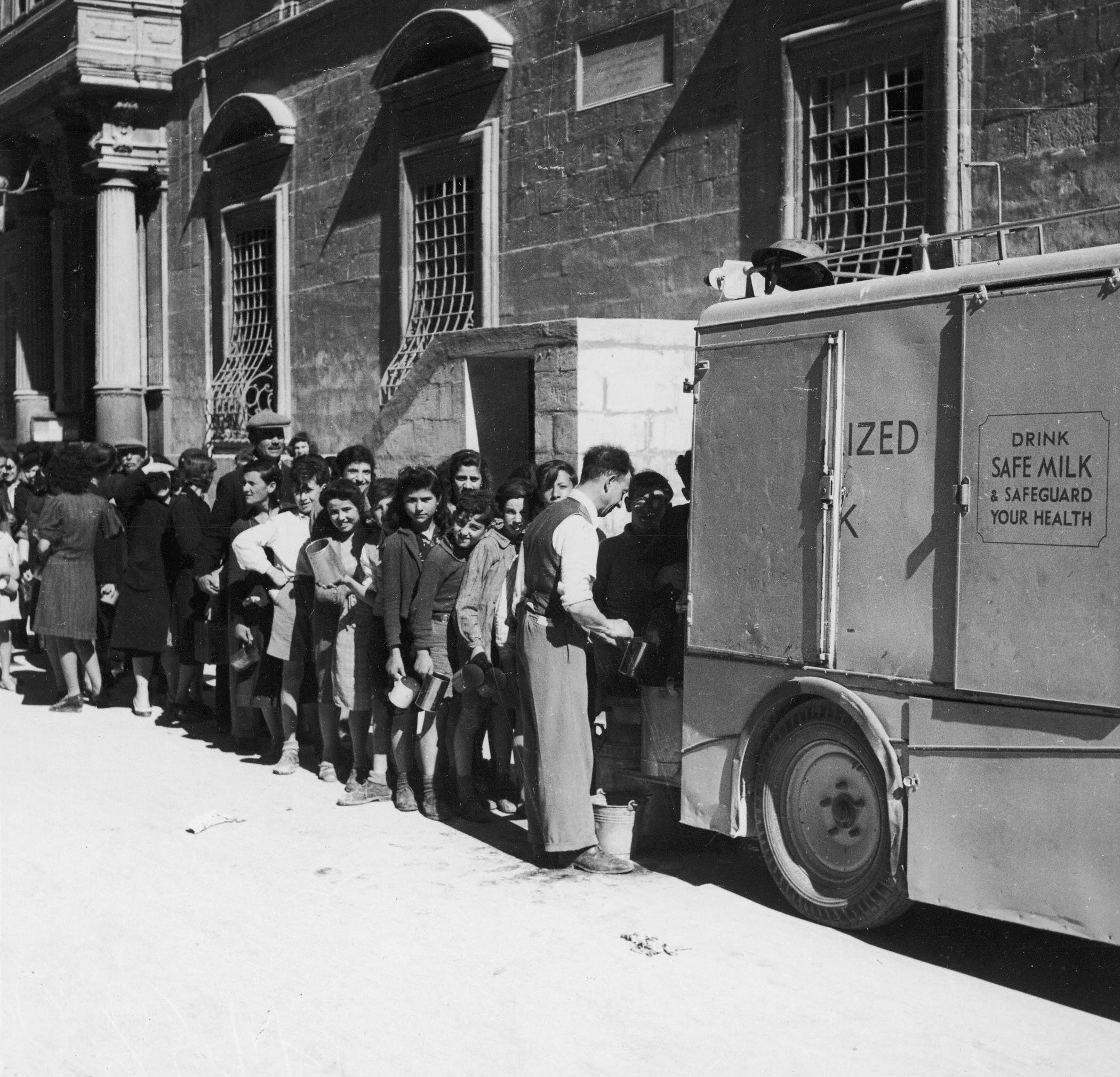 Maltese citizens lining up for milk rations while under siege during WWII.